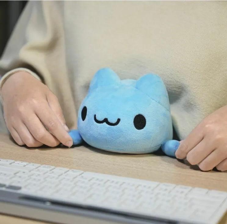 Capoo Desk Lying Plush on desk with a person holding its hand